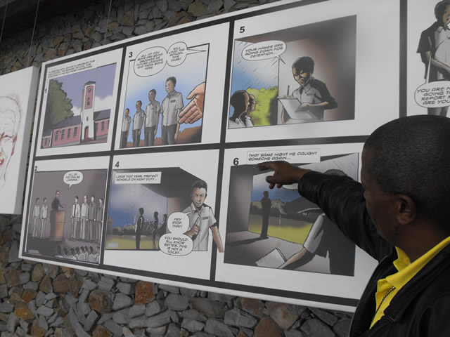 Tour guide Monde Mgodlana goes through a selection of Nelson Mandela comic series displayed at Nelson Mandela Museum in Qunu. Source: SAnews