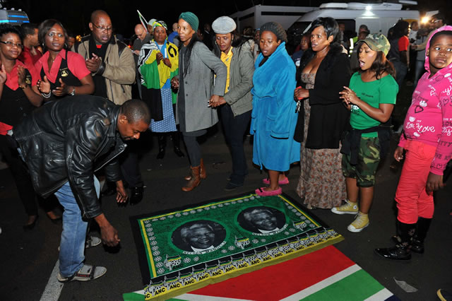 Mourners holding a night vigil in song and dance outside the late former President Nelson Mandela's Home in Houghton. Source: GCIS