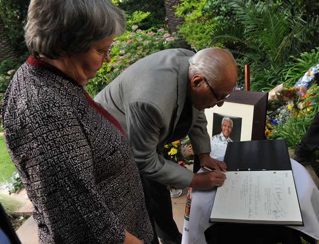 ANC stalwart Ahmed Kathrada and former Minister Barbara Hogan sign the registry book Mandela's house in Houghton. Source: GCIS  