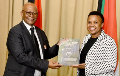 The Secretary of the Commission Prof Itumeleng Mosala presents the second part of the Judicial Commission of Inquiry into Allegations of State Capture, Corruption and Fraud report to the Director-General in the Presidency Ms Phindile Baleni. 